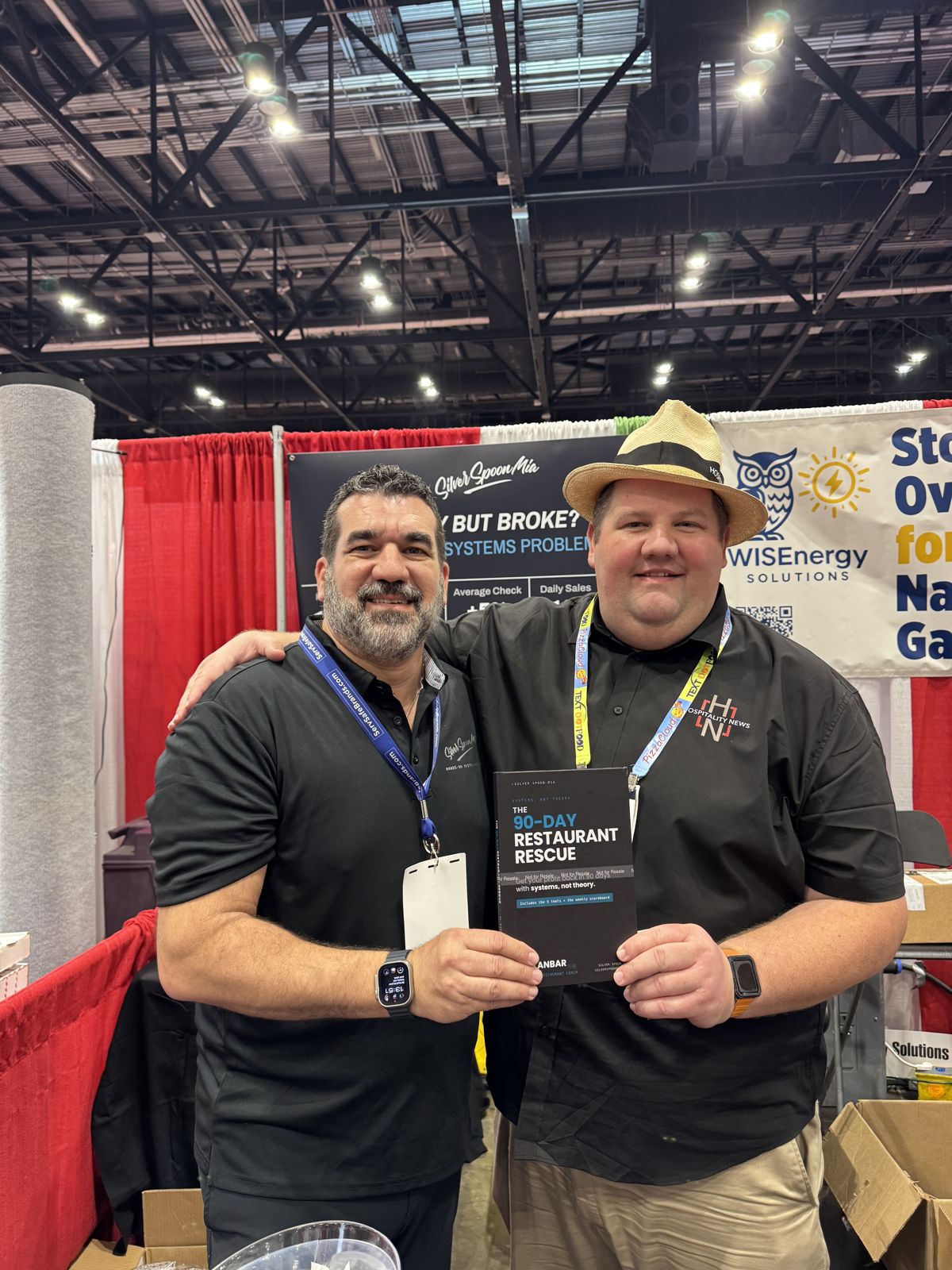 Al Kanbar with a reader holding The 90-Day Restaurant Rescue at the Florida Restaurant Show